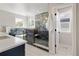 Bright bathroom with standalone tub, glass shower and modern gray tile accents at 2515 N Gaylord St, Denver, CO 80205