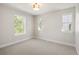 Spacious, carpeted bedroom with three bright windows at 2515 N Gaylord St, Denver, CO 80205