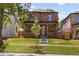 Attractive brick home with a covered front porch and fresh landscaping at 2515 N Gaylord St, Denver, CO 80205