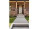 Close-up of a modern front door framed by brick columns and stylish lighting fixtures at 2515 N Gaylord St, Denver, CO 80205