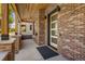 Charming front porch featuring a brick facade, wood ceiling and a modern door at 2515 N Gaylord St, Denver, CO 80205