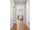 Inviting hallway featuring hardwood floors, white trim, and a view into a sunlit living space at 2515 N Gaylord St, Denver, CO 80205