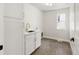 Bright laundry room with white cabinets, sink, gold faucet, and a window for natural light at 2515 N Gaylord St, Denver, CO 80205