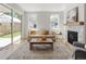Living room with fireplace, sliding glass doors leading outside and neutral colored sofa at 2515 N Gaylord St, Denver, CO 80205