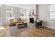 Living room with many windows, fireplace, wood floors, neutral colored sofa and gray chair at 2515 N Gaylord St, Denver, CO 80205
