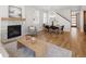 Open concept living space with fireplace, dining area and wood flooring throughout at 2515 N Gaylord St, Denver, CO 80205