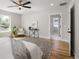 Main bedroom with ceiling fan, wood floors, large windows, and attached bathroom at 2515 N Gaylord St, Denver, CO 80205