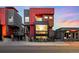 Striking multi-level modern home with bold red accents, large windows, and professional landscaping at 3334 Tejon St # 1, Denver, CO 80211