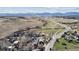 A wider aerial view displays the landscape, roads, and surrounding hills, presenting its locale at 8182 3Rd Ave, Arvada, CO 80007