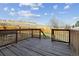 Outdoor back deck offers a peaceful setting with its wooden fence and hill views at 8182 3Rd Ave, Arvada, CO 80007
