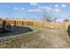 Backyard view showing the wood fence, yard, and a portion of the deck at 8182 3Rd Ave, Arvada, CO 80007