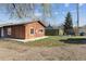Backyard view of the house featuring its siding and roof at 8182 3Rd Ave, Arvada, CO 80007