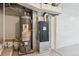 Basement with the home's mechanicals including a gas furnace and water heater at 8182 3Rd Ave, Arvada, CO 80007
