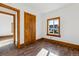 Bedroom featuring a wood framed window, neutral walls, and wood laminate flooring at 8182 3Rd Ave, Arvada, CO 80007