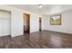 Spacious bedroom features wood floors, white walls, window with view, and entry to the en suite at 8182 3Rd Ave, Arvada, CO 80007