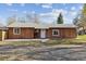 Inviting single-story home with a spacious front yard and a classic design at 8182 3Rd Ave, Arvada, CO 80007