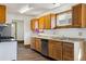 Cozy kitchen featuring wooden cabinets, updated appliances, and ample counter space at 8182 3Rd Ave, Arvada, CO 80007