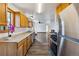 Bright kitchen with wooden cabinets, stainless steel appliances, and functional design at 8182 3Rd Ave, Arvada, CO 80007