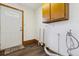 Mudroom with a white exterior door, wood look floors, and wood cabinets at 8182 3Rd Ave, Arvada, CO 80007