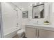 Bathroom featuring a shower over tub, floating vanity, and black framed mirror at 3657 Pecos St, Denver, CO 80211