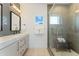 Modern bathroom featuring double vanity, walk-in shower with seating, and stylish tile work at 3657 Pecos St, Denver, CO 80211