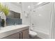 Modern bathroom with a sleek vanity, stylish mirror, and a combined tub and shower at 3657 Pecos St, Denver, CO 80211