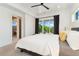 Spacious bedroom with a balcony, large window, and modern fixtures, offering a comfortable and stylish living space at 3657 Pecos St, Denver, CO 80211