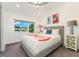 Bedroom featuring a queen bed, light grey carpet, and side tables with lamps at 3657 Pecos St, Denver, CO 80211