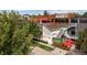 Street-level exterior shot of Avanti restaurant featuring wooden accents, red umbrellas, and lush greenery at 3657 Pecos St, Denver, CO 80211