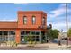 Eye-catching building of Pinwheel Coffee featuring a brick and orange exterior with large windows at 3657 Pecos St, Denver, CO 80211