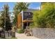 Exterior view of The Gathering Jones featuring a modern design with wood accents and lush greenery at 3657 Pecos St, Denver, CO 80211