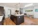 Modern kitchen with a large island, stainless steel appliances, and a dining area, perfect for Gathering meals and entertaining at 3657 Pecos St, Denver, CO 80211