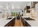 Well-lit modern kitchen with stainless steel appliances, granite countertops, and an open floor plan leading to the living area at 3657 Pecos St, Denver, CO 80211