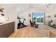 Living room featuring light hardwood floors, a ceiling fan, and sliding glass doors to balcony at 3657 Pecos St, Denver, CO 80211
