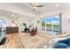 Living room featuring hardwood floors, Peloton bike, and sliding glass doors to balcony at 3657 Pecos St, Denver, CO 80211