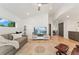 Living room with light hardwood floors, neutral sofa, and large television at 3657 Pecos St, Denver, CO 80211