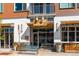 Restaurant entrance featuring an inviting storefront with outdoor seating and vibrant landscaping at 3657 Pecos St, Denver, CO 80211
