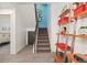 Bright stairway showcasing a modern design with unique artwork and a decorative shelving unit at 3657 Pecos St, Denver, CO 80211