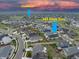 An aerial view showing a neighborhood layout with views of the clubhouse and the location of the home at 565 Pikes View at 565 Pikes View Dr, Erie, CO 80516