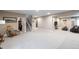 Spacious finished basement with a versatile layout, ideal for recreation or relaxation with a lounge and staircase at 565 Pikes View Dr, Erie, CO 80516