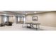 Open basement featuring a lounge area, dining space, and ping pong table provides ample room for activities at 565 Pikes View Dr, Erie, CO 80516