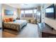 Serene bedroom with large windows, plush bedding, and stylish decor for a peaceful retreat at 565 Pikes View Dr, Erie, CO 80516