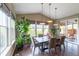 Elegant dining room with large windows, stylish lighting, and a spacious table for gatherings at 565 Pikes View Dr, Erie, CO 80516