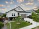 Charming home with a well-manicured lawn, beautiful landscaping, and a welcoming two-car garage at 565 Pikes View Dr, Erie, CO 80516