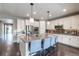 Modern kitchen with a large center island, stainless steel appliances, and ample cabinet space at 565 Pikes View Dr, Erie, CO 80516