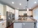 Bright, airy kitchen features an island, stainless steel appliances, and pendant lighting at 565 Pikes View Dr, Erie, CO 80516