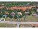 Stunning aerial view of homes nestled near a striking red rock formation and lush green trees at 5085 Red Rock Dr, Larkspur, CO 80118