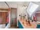 Bathroom vanity featuring a copper sink, tile countertop, and a shower with a window at 5085 Red Rock Dr, Larkspur, CO 80118