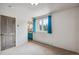 Spacious bedroom with a view of the ensuite bathroom and wooded outdoor view at 5085 Red Rock Dr, Larkspur, CO 80118