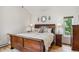 A well-appointed primary bedroom showcasing a wooden sleigh bed and matching nightstands at 5085 Red Rock Dr, Larkspur, CO 80118